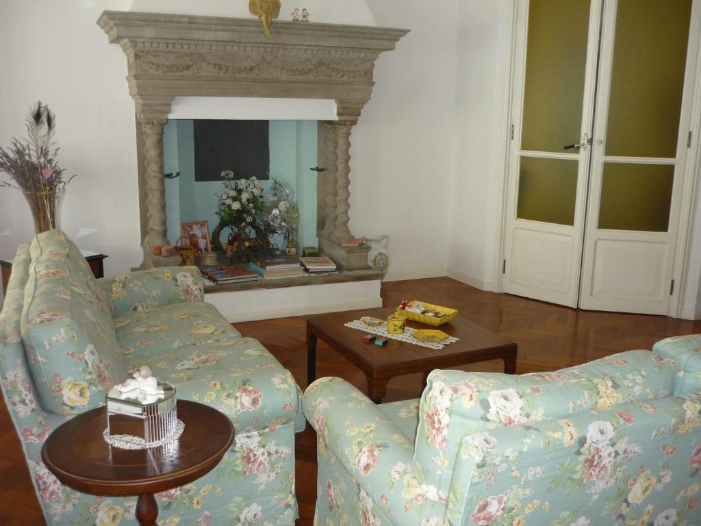 a living room with two couches and a table at Il Giardino Segreto in Imola