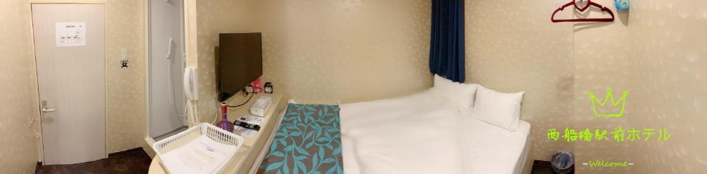 Posteľ alebo postele v izbe v ubytovaní Nishifunabashi Ekimae Hotel
