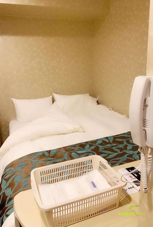 Posteľ alebo postele v izbe v ubytovaní Nishifunabashi Ekimae Hotel