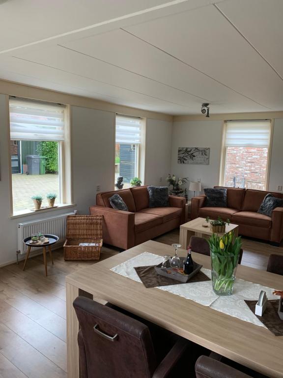 a living room with a couch and a table at Skoallehus vakantiewoning in De Bult