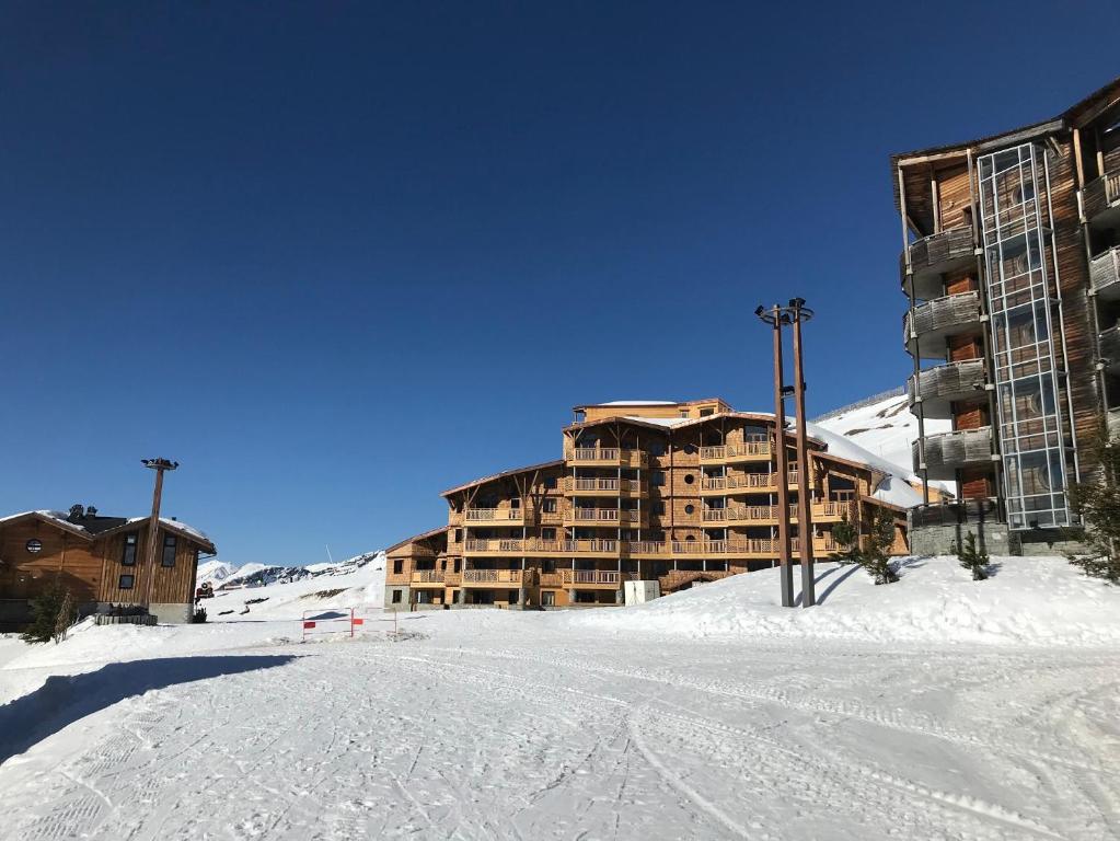 a ski lodge in the snow next to a ski slope at Residence Arietis - maeva Home in Avoriaz