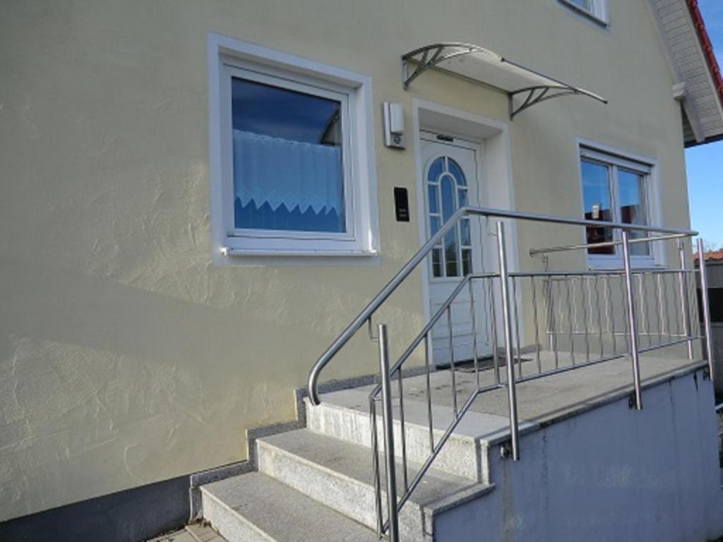 a building with stairs and a window and a door at Ferienwohnung Stella in Ichenhausen