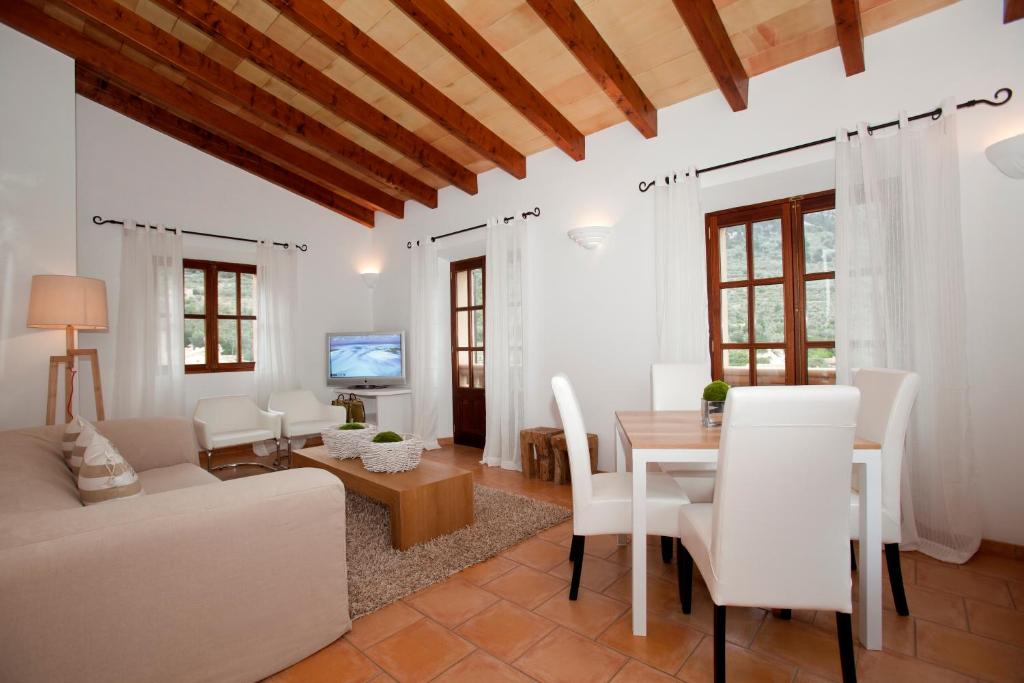 
a living room filled with furniture and a large window at Hotel Apartament Sa Tanqueta De Fornalutx - Adults Only in Fornalutx

