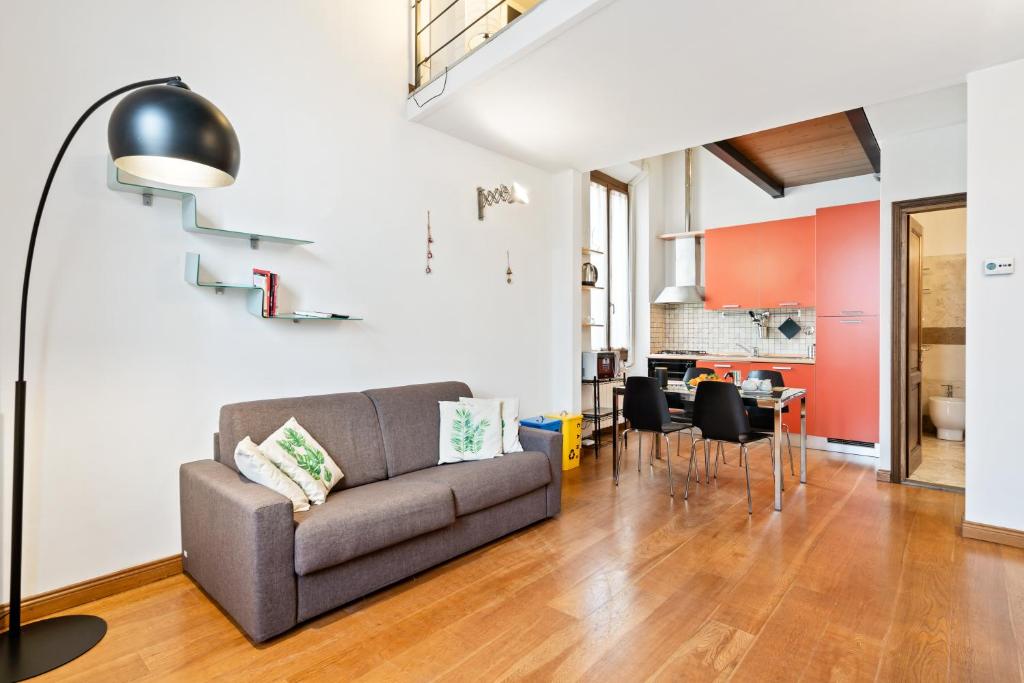 ein Wohnzimmer mit einem Sofa und einem Tisch in der Unterkunft Rifredi & Dalmazia Modern Loft in Florenz