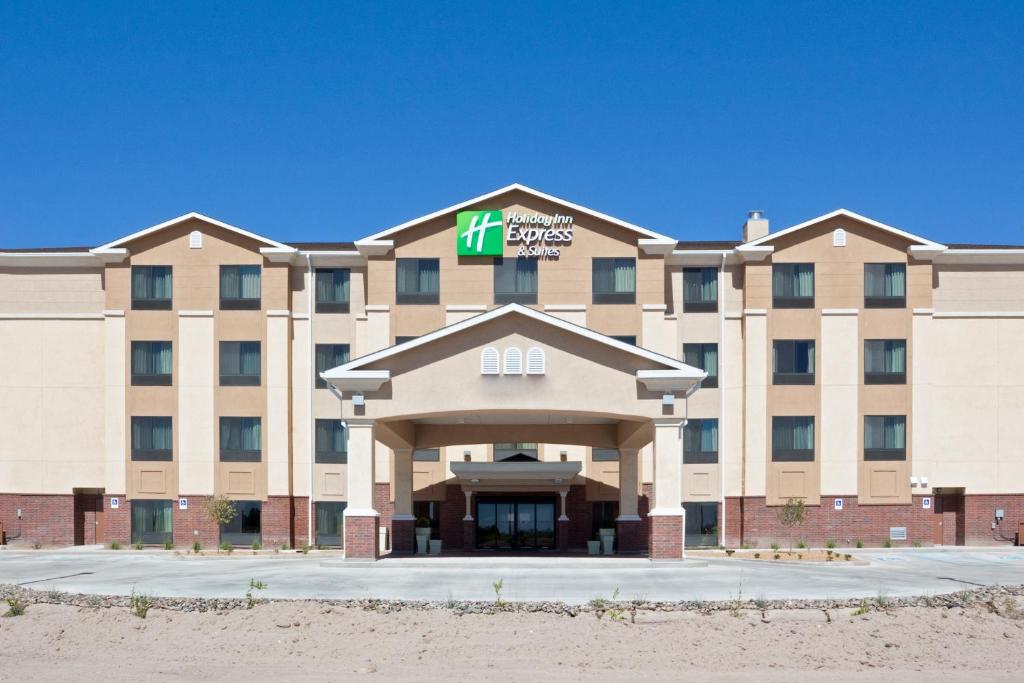 a large tan building with a sign on it at Holiday Inn Express & Suites Deming Mimbres Valley, an IHG Hotel in Deming