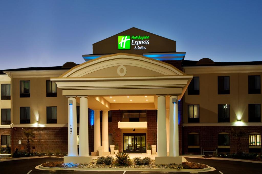 a hotel with a sign on top of a building at Holiday Inn Express Hotel & Suites Picayune by IHG in Picayune