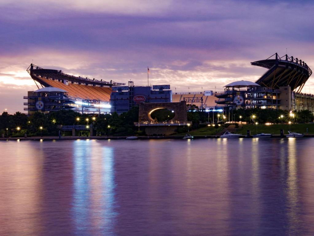 a view of a stadium at night with a large body of water at Holiday Inn Express & Suites Pittsburgh North Shore by IHG in Pittsburgh