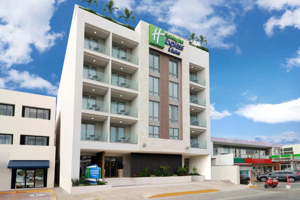 
a large building with a large building behind it at Holiday Inn Express & Suites - Playa del Carmen, an IHG Hotel in Playa del Carmen

