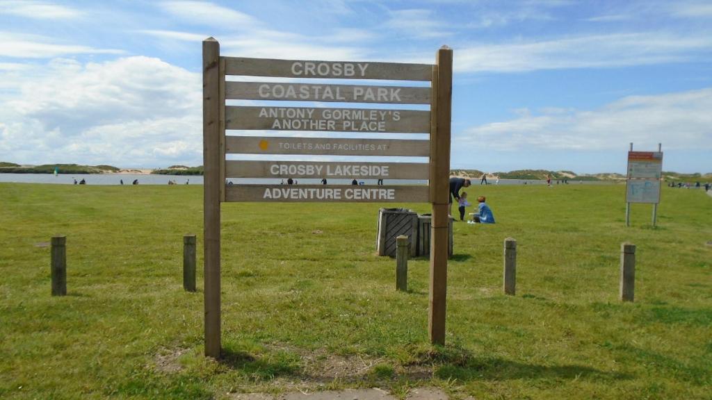 a sign in the grass next to a field at TEA in Liverpool - Private - Quiet - Ground Floor - En-suite - Walk-in-shower in Liverpool