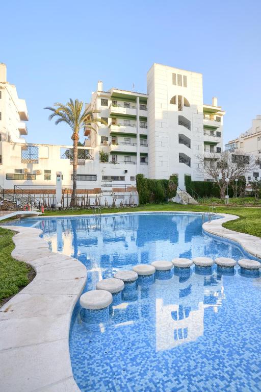 a large swimming pool in front of a building at Apartamentos BCL Playa Albir in Albir