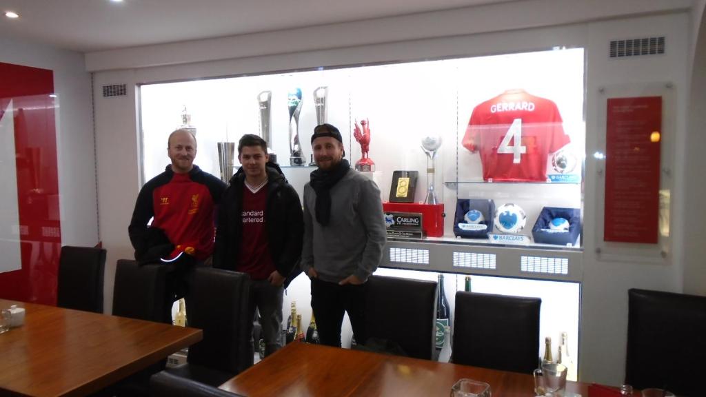 a group of three men standing in a restaurant at TEA in Liverpool - Private - Quiet - Ground Floor - En-suite - Walk-in-shower in Liverpool