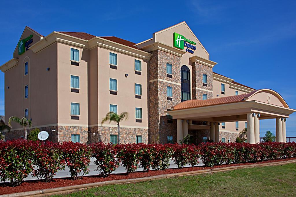 a hotel with red flowers in front of a building at Holiday Inn Express Texas City, an IHG Hotel in Texas City