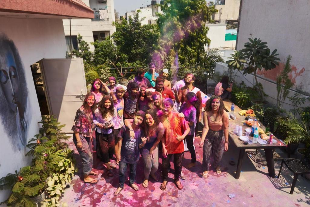 a group of people covered in holi paint at The Desire Hostel in New Delhi