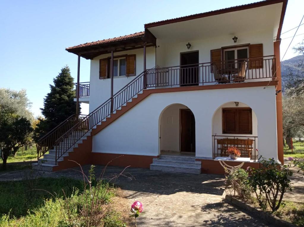 a house with a staircase in front of it at manousi 2 - First floor in Mystras