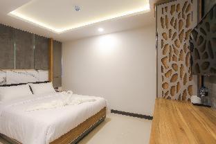 a bedroom with a large bed in a room at The Mantra Hotel Kata Noi in Kata Beach