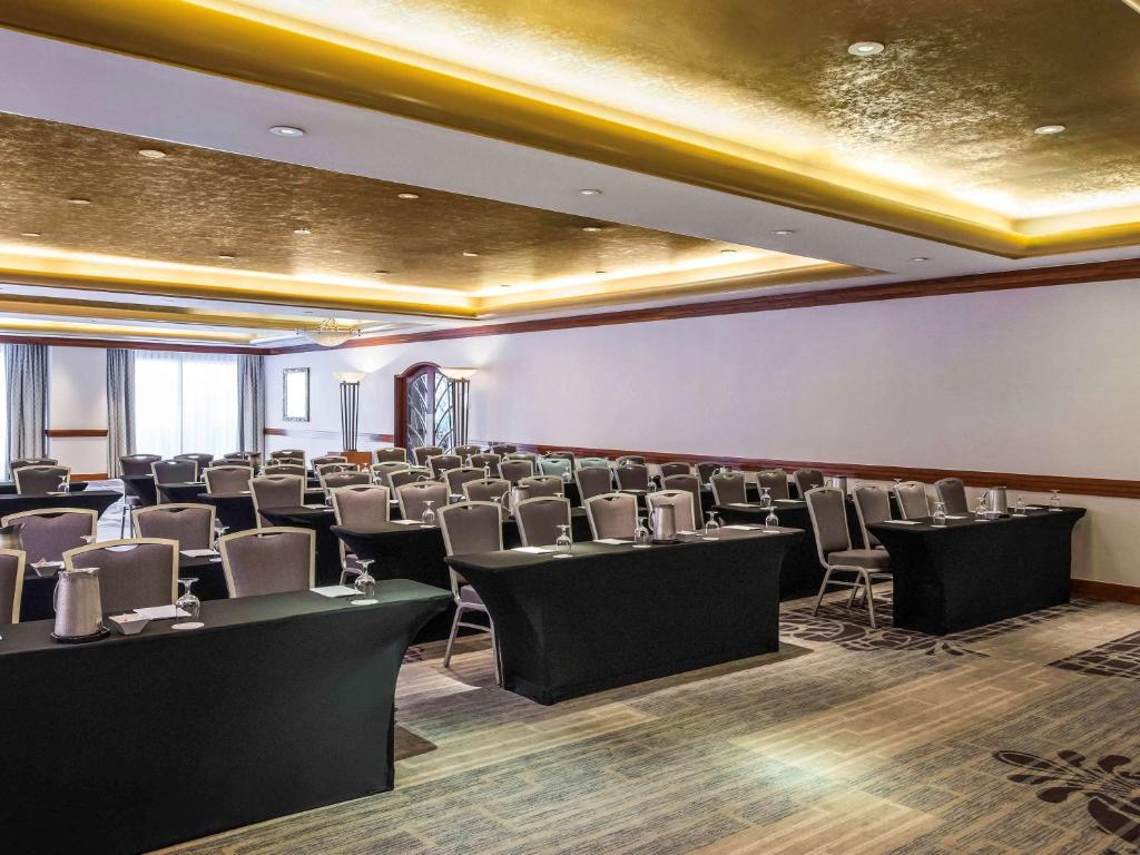 a conference room with chairs and tables and ceilings at Pullman Miami Airport in Miami