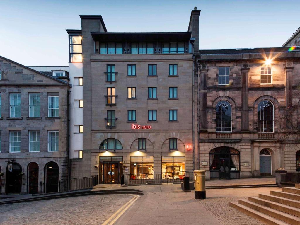 a large building with a clock on the side of it at ibis Edinburgh Centre Royal Mile – Hunter Square in Edinburgh