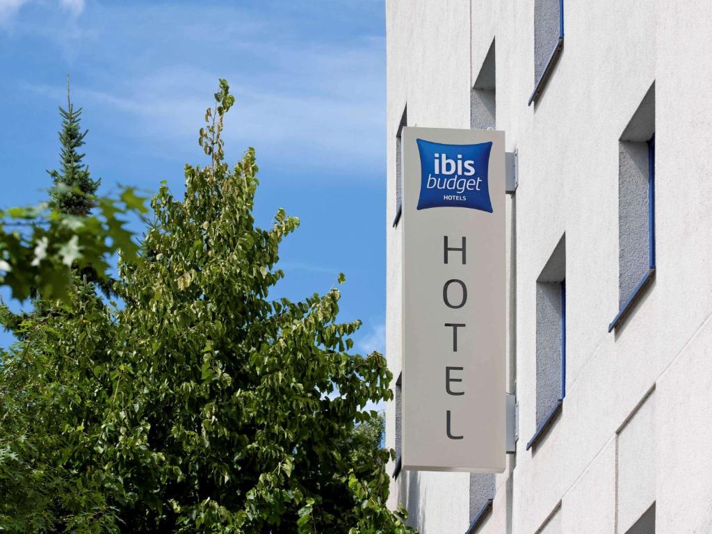 a sign on the side of a building with ahs college at ibis budget Hamburg Altona in Hamburg