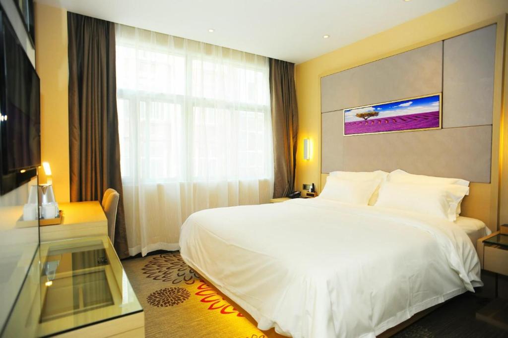 Lavande Hotels·Hangzhou Xiaoshan International Airport في هانغتشو: غرفة نوم بسرير ابيض كبير ونافذة