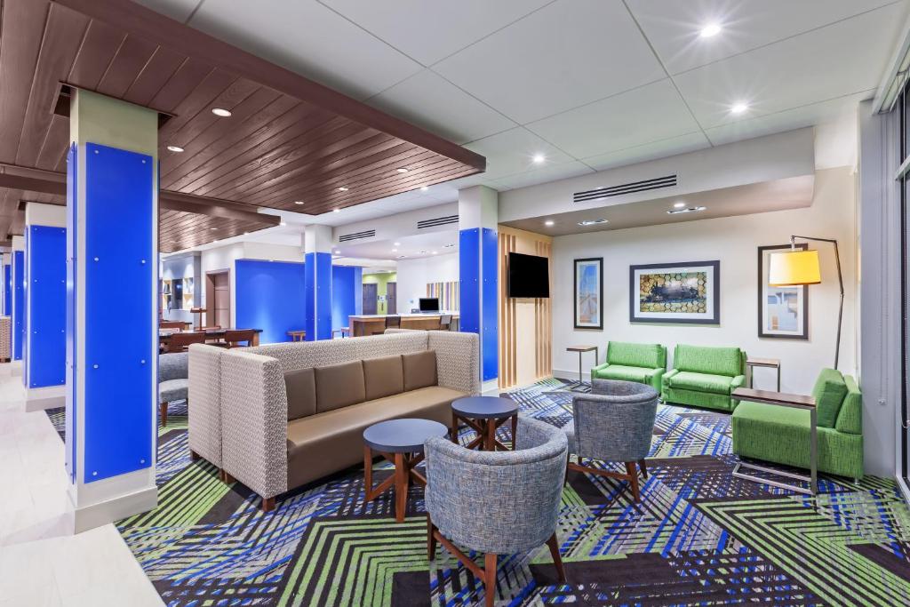 a lobby with a couch and chairs and tables at Holiday Inn Express and Suites Chanute, an IHG Hotel in Chanute