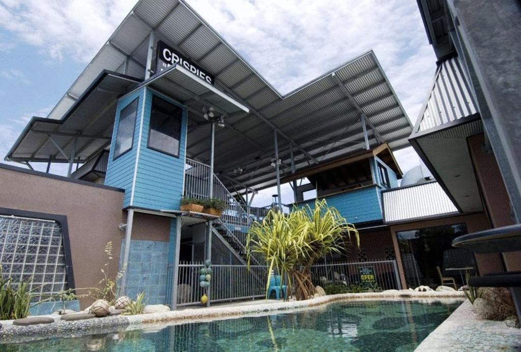 a building with a swimming pool in front of it at Aspect Central in Cairns