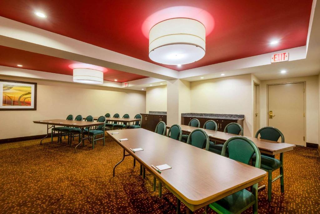 a conference room with tables and chairs and red ceilings at La Quinta Inn & Suites - New River Gorge National Park in Summersville