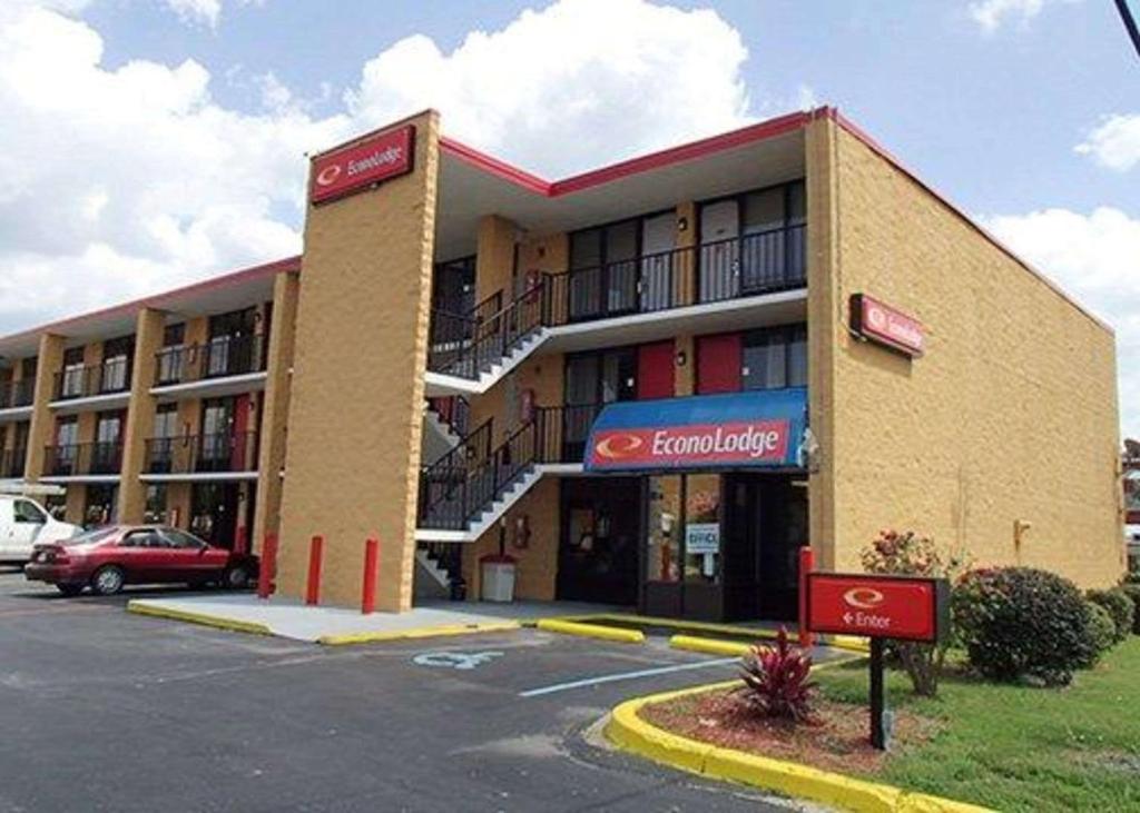 a large building with a car parked in a parking lot at Econo Lodge in Rock Hill