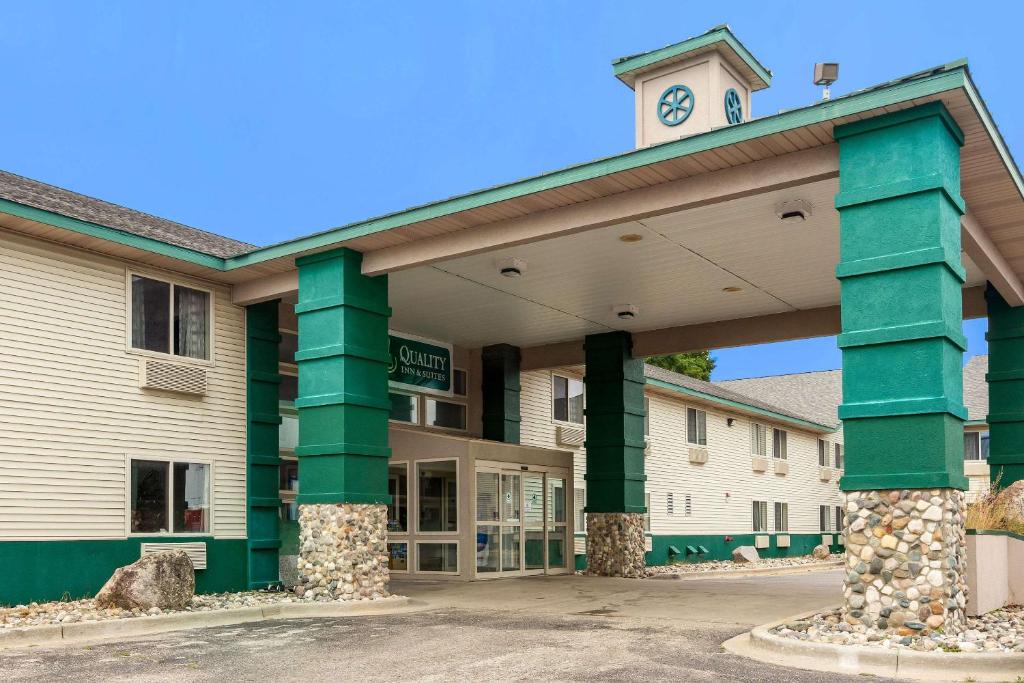 a building with green columns and a clock tower at Quality Inn in Clare