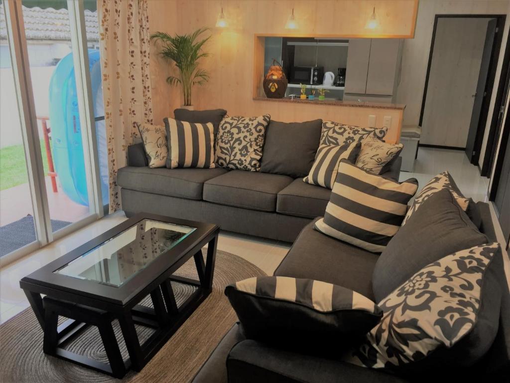a living room with a couch and a coffee table at Nago - House / Vacation STAY 76289 in Nago