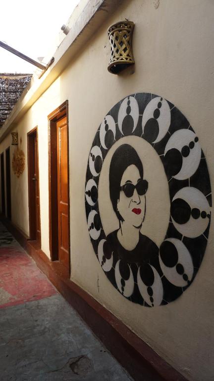 a painting of a woman on the side of a building at Dahab Hostel in Cairo