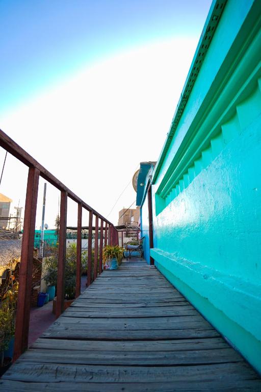 a wooden walkway leading down to the beach at Dahab Hostel in Cairo