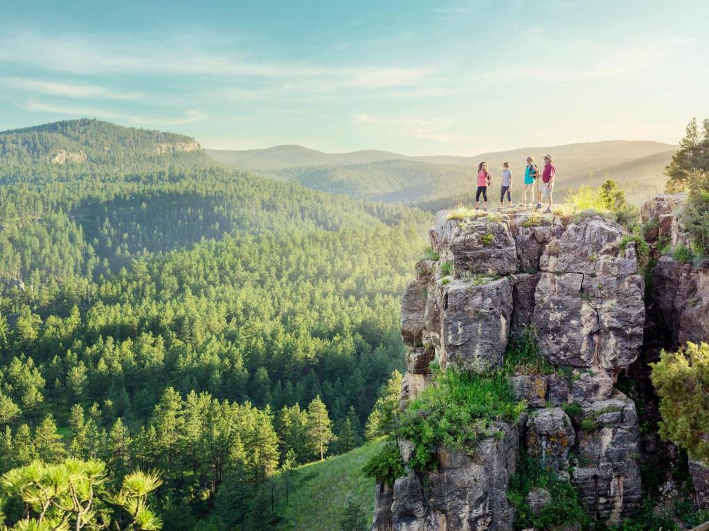 a group of people standing on top of a mountain at Holiday Inn Express & Suites - Rapid City - Rushmore South by IHG in Rapid City