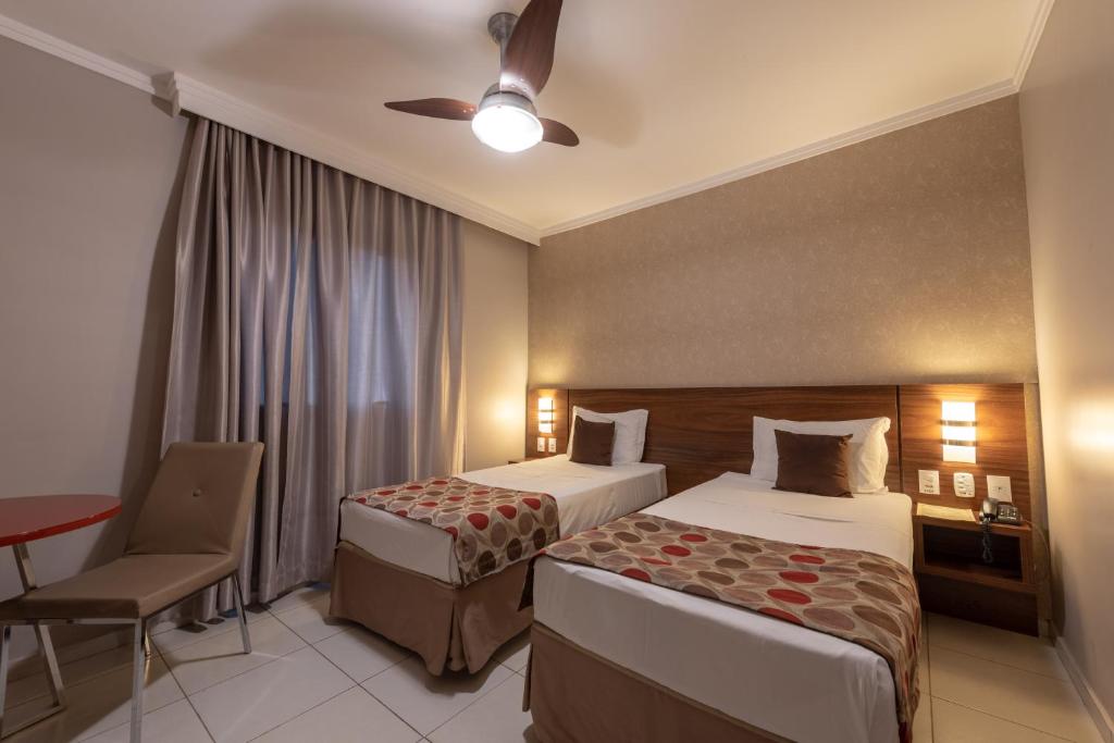 Postel nebo postele na pokoji v ubytování Class Hotel Pouso Alegre