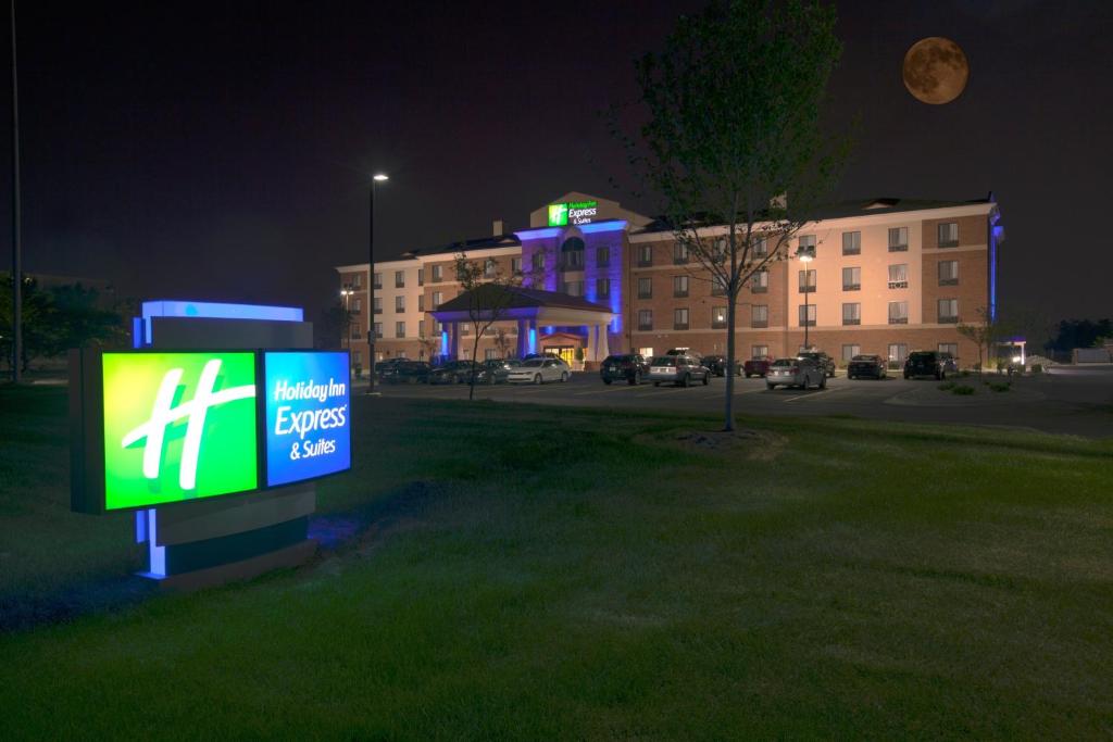 a sign in the grass in a city at night at Holiday Inn Express and Suites Detroit North-Troy, an IHG Hotel in Troy