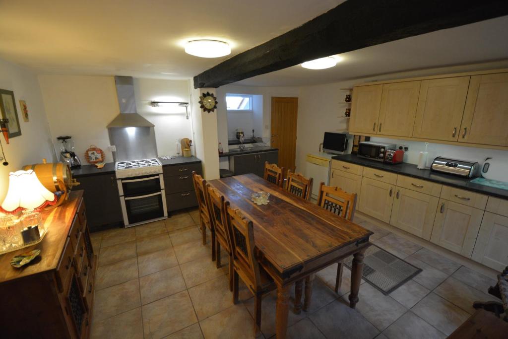 an overhead view of a kitchen with a wooden table and chairs at Pier Cottage in Watchet