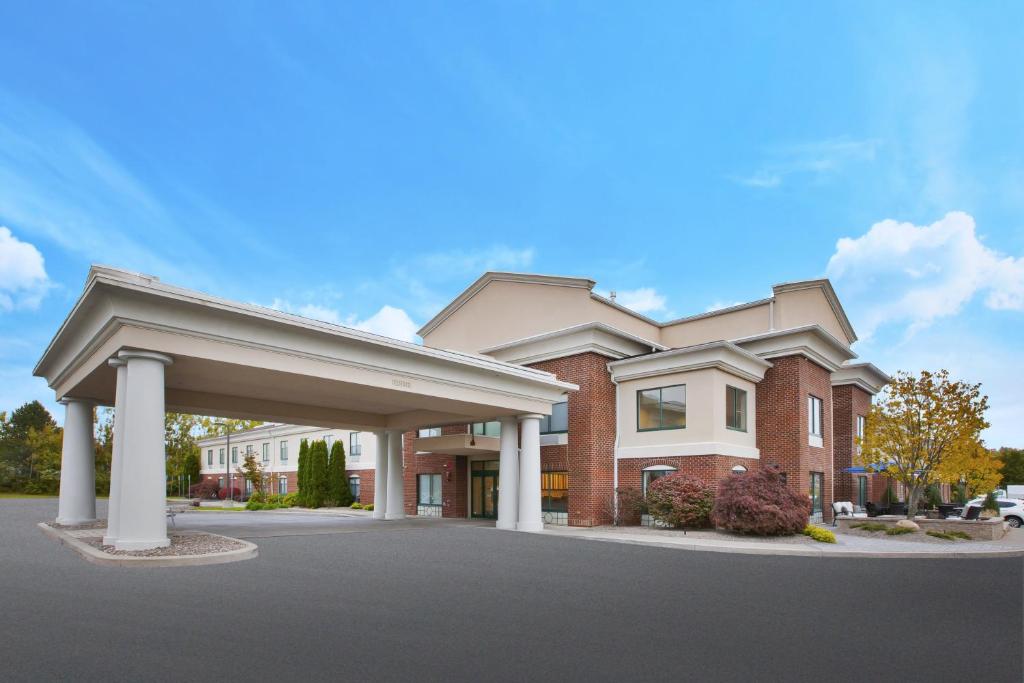 a large red brick building with a garage at Holiday Inn Express Rochester-Victor, an IHG Hotel in Victor