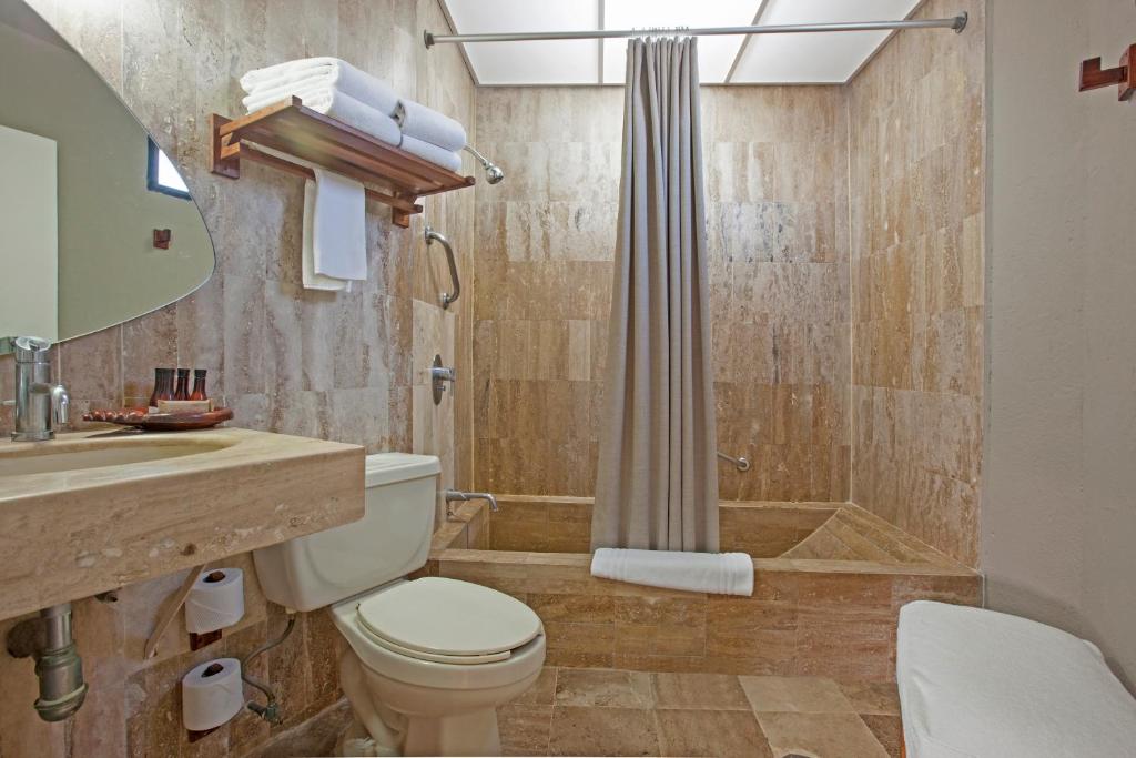 a bathroom with a toilet and a shower and a sink at Gaviana Resort in Mazatlán