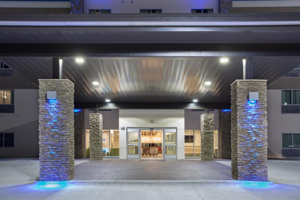 a lobby of a building with columns and lights at Holiday Inn Express & Suites Lincoln I - 80, an IHG Hotel in Lincoln