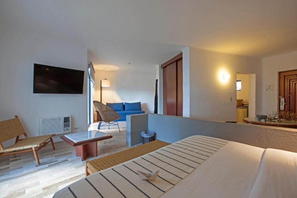 a hotel room with a bed and a living room at Gaviana Resort in Mazatlán