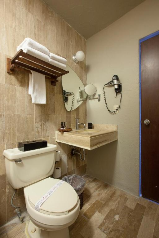 a bathroom with a toilet and a sink at Gaviana Resort in Mazatlán