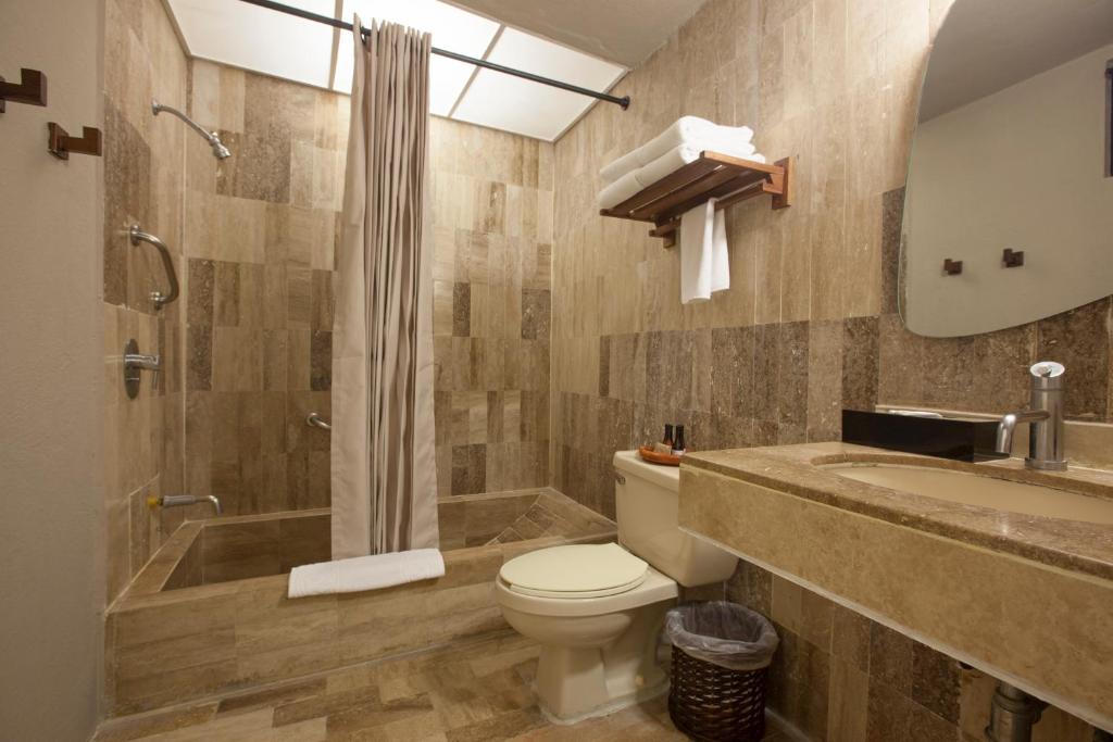 a bathroom with a toilet and a shower and a sink at Gaviana Resort in Mazatlán