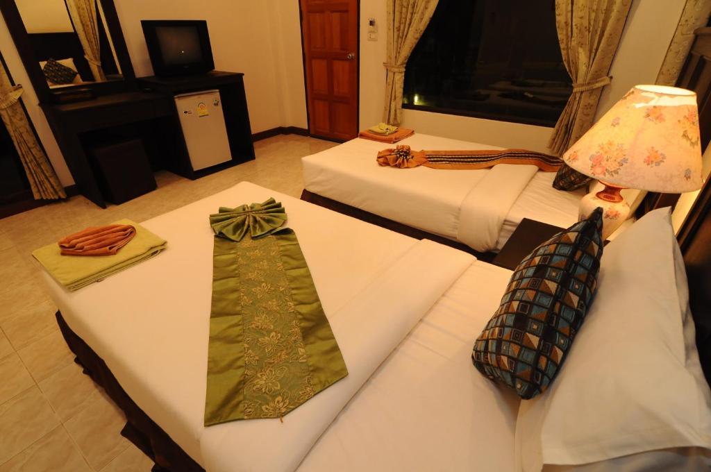 Postel nebo postele na pokoji v ubytování N.T. Lanta Resort