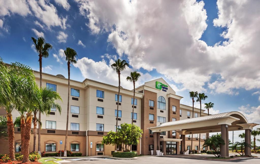 法爾的住宿－法爾假日套房酒店，一座楼前有棕榈树的酒店