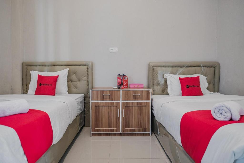 Postel nebo postele na pokoji v ubytování RedDoorz Syariah at Hotel Grand Mentari