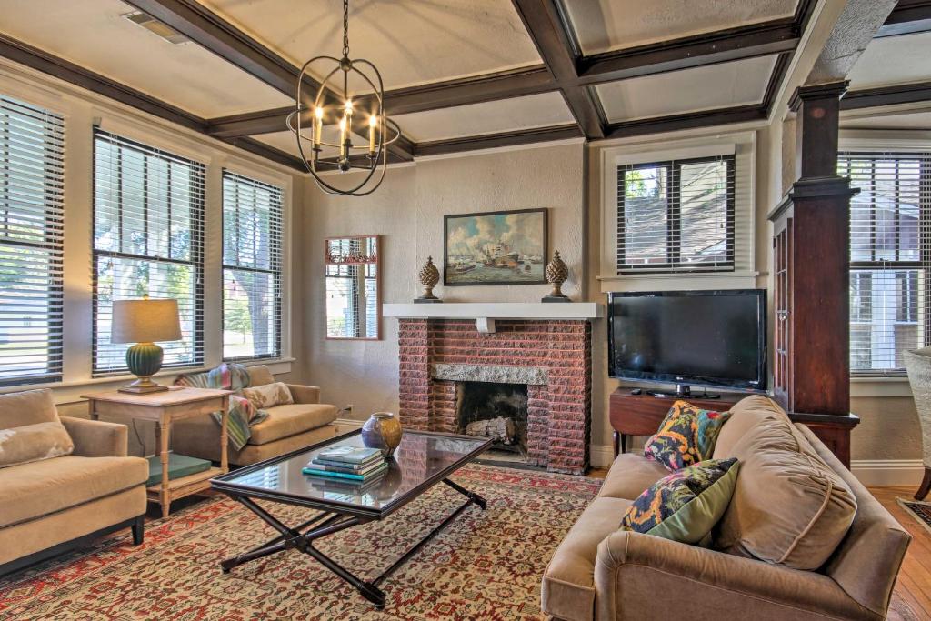 a living room with a fireplace and a tv at Charming 1916 Bungalow about 3 Miles to Augusta Course in Augusta