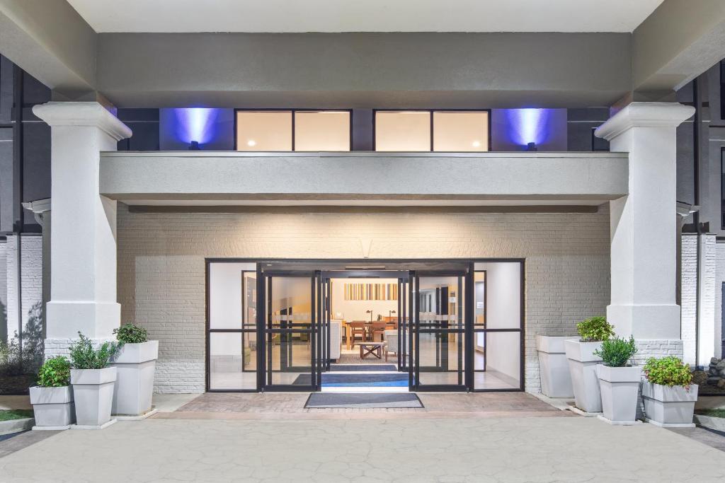 a front entrance to a building with glass doors at Holiday Inn Express Hotels & Suites Greenville-Spartanburg/Duncan by IHG in Duncan