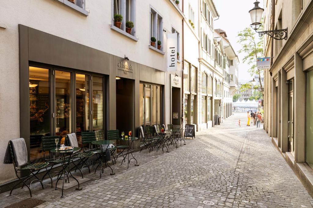 an empty street with tables and chairs in a building at Altstadt Hotel in Zurich