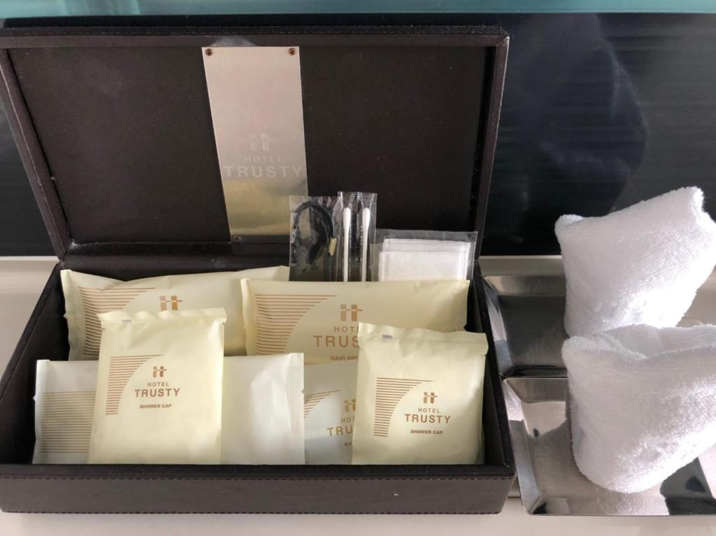 a black box filled with white pillows and towels at Hotel Trusty Osaka Abeno in Osaka