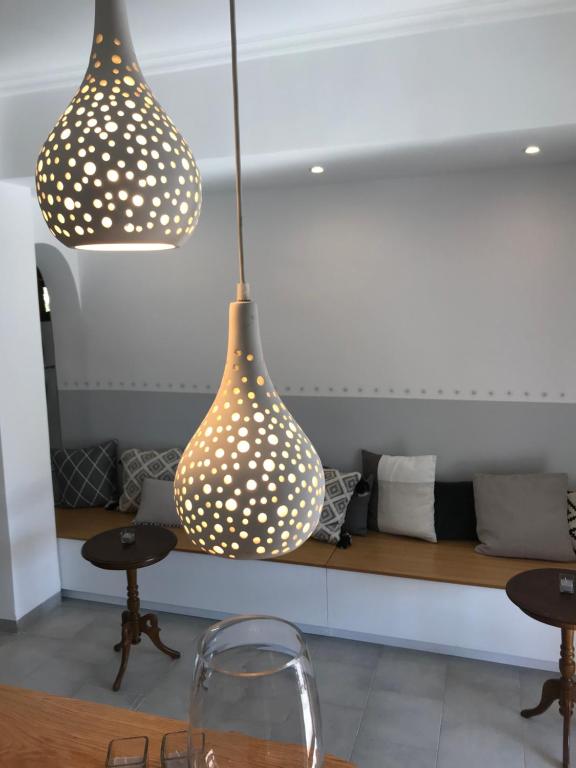 two lights hanging from the ceiling in a room at NEFELI apartments in Poros