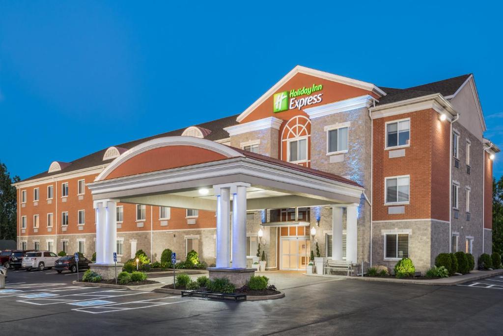 a hotel with a sign on the front of a building at Holiday Inn Express Hotel & Suites 1000 Islands - Gananoque, an IHG Hotel in Gananoque